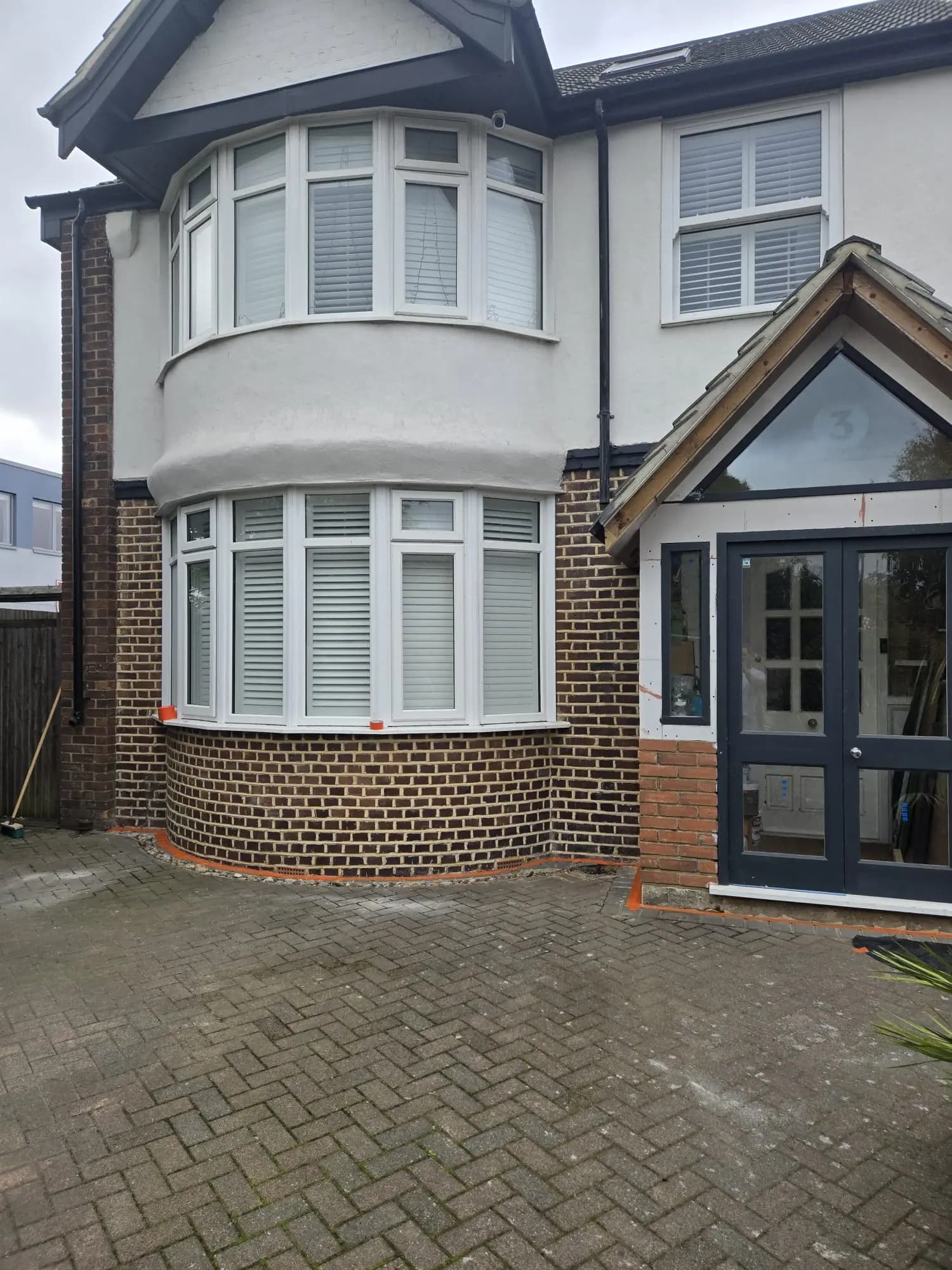 Front and side of house in Kent before silicone render covering old bricks